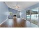 Bright Gathering room with fireplace and sliding doors leading to the pool at 4800 Pierce Arrow Dr, Apopka, FL 32712
