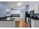 Kitchen with white cabinets, dark countertops, and stainless steel appliances at 4800 Pierce Arrow Dr, Apopka, FL 32712
