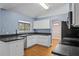 Kitchen features white cabinets, black countertops and stainless steel appliances at 4800 Pierce Arrow Dr, Apopka, FL 32712