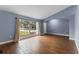 Living room featuring hardwood floors and large window at 4800 Pierce Arrow Dr, Apopka, FL 32712