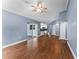 Open living room with wood-look floors and kitchen views at 4800 Pierce Arrow Dr, Apopka, FL 32712