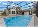 Inviting pool area with screened enclosure, expansive patio, and modern pavers at 4800 Pierce Arrow Dr, Apopka, FL 32712