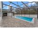 Relaxing pool and patio area with a screened enclosure at 4800 Pierce Arrow Dr, Apopka, FL 32712