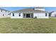 Large backyard featuring a well-maintained lawn and a covered patio area at 5000 Northern Dove Ave, Mount Dora, FL 32757