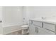 Clean bathroom featuring a tub-shower combination and vanity with sleek gray cabinetry at 5000 Northern Dove Ave, Mount Dora, FL 32757