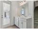 Bathroom boasts double sinks, white cabinetry, and access to a screened lanai at 5000 Northern Dove Ave, Mount Dora, FL 32757