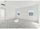 Bright bedroom with plush carpeting, large windows offering serene neighborhood views at 5000 Northern Dove Ave, Mount Dora, FL 32757
