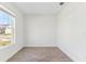 Well-lit room with wood-look tile floors and a large window providing a view of the neighborhood at 5000 Northern Dove Ave, Mount Dora, FL 32757