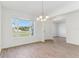 Inviting dining room with a chandelier, wood-look tile floors, and abundant natural light at 5000 Northern Dove Ave, Mount Dora, FL 32757