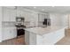 Modern kitchen featuring gray cabinets, stainless steel appliances, and a large island at 5000 Northern Dove Ave, Mount Dora, FL 32757