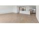 Bright and airy open concept living room and kitchen with modern tile flooring and breakfast bar seating at 5000 Northern Dove Ave, Mount Dora, FL 32757