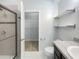 Bathroom with walk-in shower, toilet, and floating shelves at 510 Rainbow Springs Loop, Groveland, FL 34736