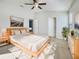 Bright and spacious primary bedroom with wood-like flooring and neutral decor at 510 Rainbow Springs Loop, Groveland, FL 34736