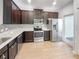 Modern kitchen with dark cabinetry, stainless steel appliances, and white countertops at 510 Rainbow Springs Loop, Groveland, FL 34736