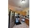 Galley kitchen with stainless steel appliances at 517 Cardinal Dr, Kissimmee, FL 34759