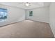 Large carpeted bedroom with neutral walls and ample natural light at 5803 Sw 107Th St, Ocala, FL 34476