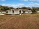 Front view of single-story home with a neatly landscaped yard at 5803 Sw 107Th St, Ocala, FL 34476