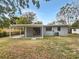 Home features a covered patio and a fenced-in backyard at 6117 Oakcrest Cir, Orlando, FL 32808