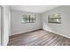 Bedroom with wood-look floors and large windows at 6117 Oakcrest Cir, Orlando, FL 32808