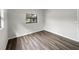 Simple bedroom with light walls and wood-look floors at 6117 Oakcrest Cir, Orlando, FL 32808