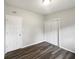 Empty bedroom with wood-look floors and double door closet at 6117 Oakcrest Cir, Orlando, FL 32808