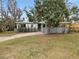 Newly painted house with landscaped yard and driveway at 6117 Oakcrest Cir, Orlando, FL 32808