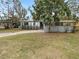 Newly painted house with landscaped yard and driveway at 6117 Oakcrest Cir, Orlando, FL 32808