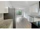 Remodeled kitchen with stainless steel appliances and granite countertops at 6117 Oakcrest Cir, Orlando, FL 32808