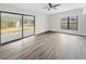 Spacious living area with large sliding glass doors and wood-look floors at 6117 Oakcrest Cir, Orlando, FL 32808
