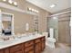 Double vanity bathroom with a large walk-in shower at 626 Brookfield Loop, Lake Mary, FL 32746
