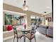 Cozy dining area with glass-top table and built-in window seat at 626 Brookfield Loop, Lake Mary, FL 32746