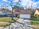 Single-story house with a brown roof, attached garage, and mature landscaping at 626 Brookfield Loop, Lake Mary, FL 32746