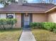 House entrance with a gray door and well-maintained landscaping at 626 Brookfield Loop, Lake Mary, FL 32746