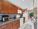 Updated kitchen with wood cabinets, granite countertops and appliances at 626 Brookfield Loop, Lake Mary, FL 32746