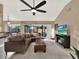 Relaxing living room with sectional sofa and large TV at 626 Brookfield Loop, Lake Mary, FL 32746