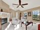 Living room with a fireplace, seating area and lots of natural light at 626 Brookfield Loop, Lake Mary, FL 32746