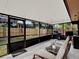 Relaxing screened porch with patio furniture at 626 Brookfield Loop, Lake Mary, FL 32746