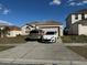 Two-car driveway and a charming house with a well-maintained lawn at 6868 Westlake Blvd, Orlando, FL 32810