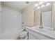 Bright bathroom featuring a shower-tub combo with white tiling and a white single sink vanity at 8307 Fontera Dr, Davenport, FL 33896