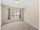 Comfortable bedroom featuring a window and neutral-toned walls and flooring at 8307 Fontera Dr, Davenport, FL 33896