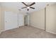 Bedroom with a ceiling fan, double door closet, and a secondary door for easy access at 8307 Fontera Dr, Davenport, FL 33896