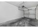 Attached garage with white walls, concrete floor, and a sectional garage door at 8307 Fontera Dr, Davenport, FL 33896