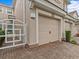 Two-car garage with tan door and white gate at 8307 Fontera Dr, Davenport, FL 33896