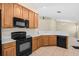 Open kitchen with black appliances, white countertops, and light-colored cabinets at 8307 Fontera Dr, Davenport, FL 33896