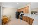 Functional kitchen with wooden cabinets, black appliances, and an adjacent dining area at 8307 Fontera Dr, Davenport, FL 33896