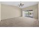Spacious living room featuring a ceiling fan and sliding glass doors leading to an outdoor view at 8307 Fontera Dr, Davenport, FL 33896