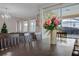 Elegant dining room showcasing a wooden table, a centerpiece, and natural light at 9030 Sunshine Ridge Loop, Kissimmee, FL 34747