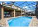 Enclosed pool and spa with patio furniture at 9030 Sunshine Ridge Loop, Kissimmee, FL 34747