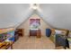 Versatile attic space with a built-in desk, carpet flooring, and a window, ideal for storage or a creative workspace at 9501 Hempel Cove Blvd, Windermere, FL 34786