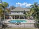 The backyard features a pristine pool, covered patio, wrought iron fence and plenty of space for outdoor activities at 9501 Hempel Cove Blvd, Windermere, FL 34786